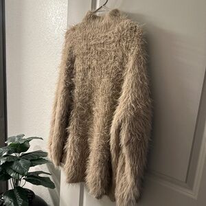 Thick turtle neck beige fuzzy sweater. Never worn no tags. Size large (8)
